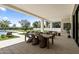 Expansive covered patio with dining area, lounge chairs, and pool access for outdoor entertaining at 12240 N 98Th St, Scottsdale, AZ 85260