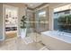 Modern bathroom featuring a glass shower, soaking tub, and custom storage at 12311 E Black Rock Rd, Scottsdale, AZ 85255