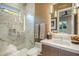 Modern bathroom with a glass shower, white marble tile, and custom lighting at 12311 E Black Rock Rd, Scottsdale, AZ 85255