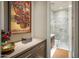 Hallway bathroom featuring a marble-clad shower with glass surround and a vanity at 12311 E Black Rock Rd, Scottsdale, AZ 85255