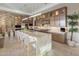 Luxurious kitchen with a stone accent wall, an oversized island, and stainless steel appliances at 12311 E Black Rock Rd, Scottsdale, AZ 85255