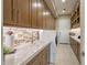 Spacious laundry room featuring ample counter space, storage cabinets, and modern washer/dryer at 12311 E Black Rock Rd, Scottsdale, AZ 85255