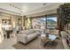 Bright living room features a modern sofa and a large sliding glass door with mountain views at 12311 E Black Rock Rd, Scottsdale, AZ 85255