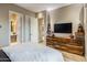 Comfortable main bedroom with a view into the main bathroom and a custom wood cabinet at 12311 E Black Rock Rd, Scottsdale, AZ 85255
