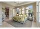 Serene main bedroom with a canopy bed, ample natural light, and a spa-like en-suite bathroom at 12311 E Black Rock Rd, Scottsdale, AZ 85255