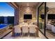 Elegant outdoor dining area with modern table, chairs, and wall-mounted TV for entertainment at 12311 E Black Rock Rd, Scottsdale, AZ 85255