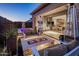 Inviting outdoor patio features a stone fire pit, cozy seating, and seamless indoor/outdoor living at 12311 E Black Rock Rd, Scottsdale, AZ 85255
