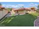 Backyard featuring manicured turf, a covered patio, and a block fence for added privacy at 12342 S Shoshoni Dr, Phoenix, AZ 85044