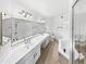 Large bathroom with dual sinks, ample vanity space, tile flooring, and glass-enclosed shower at 12342 S Shoshoni Dr, Phoenix, AZ 85044