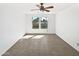 Empty bedroom with tile floors, a ceiling fan, and a large window providing natural light at 12342 S Shoshoni Dr, Phoenix, AZ 85044