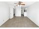 Open bedroom with tile floor, ceiling fan, open door, and access to the bathroom at 12342 S Shoshoni Dr, Phoenix, AZ 85044