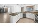 Modern kitchen featuring white cabinets, stainless steel appliances, granite countertops, and a breakfast bar at 12342 S Shoshoni Dr, Phoenix, AZ 85044