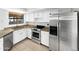 Modern kitchen featuring white cabinets, stainless steel appliances, and granite countertops at 12342 S Shoshoni Dr, Phoenix, AZ 85044