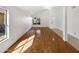 Bright living room with white walls and wood floors, featuring a window for natural light at 12342 S Shoshoni Dr, Phoenix, AZ 85044