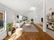 Bright living room with white walls, wood floors, and modern furnishings with a large window for natural light at 12342 S Shoshoni Dr, Phoenix, AZ 85044
