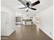 Open floor plan with tile flooring and a ceiling fan, connecting the living area to the kitchen at 12342 S Shoshoni Dr, Phoenix, AZ 85044