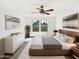 Stylish bedroom with a ceiling fan, a large bed, and two windows providing natural light at 12342 S Shoshoni Dr, Phoenix, AZ 85044