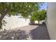Backyard area with trees, gravel landscaping, and block wall at 1285 E Mcmurray Blvd, Casa Grande, AZ 85122