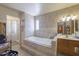 Elegant bathroom featuring a soaking tub, tiled walls, and separate shower at 1285 E Mcmurray Blvd, Casa Grande, AZ 85122
