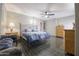 Bedroom featuring tile flooring, ceiling fan, blue bedding and a seating area at 1285 E Mcmurray Blvd, Casa Grande, AZ 85122