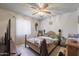 A well-lit bedroom with tile flooring, ceiling fan and a wooden bed frame at 1285 E Mcmurray Blvd, Casa Grande, AZ 85122