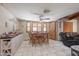 The dining area features tile flooring, a ceiling fan, a wood table with chairs, and bar seating at 1285 E Mcmurray Blvd, Casa Grande, AZ 85122
