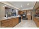 Spacious kitchen featuring wood cabinets, marble countertops and backsplash, stainless appliances, and tile floors at 1285 E Mcmurray Blvd, Casa Grande, AZ 85122