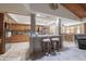 Open kitchen with counter seating, tile floors, wood cabinets, and stainless steel appliances offers a welcoming space at 1285 E Mcmurray Blvd, Casa Grande, AZ 85122