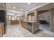 A spacious kitchen with tile floors, stainless steel appliances, and a kitchen island for food preparation at 1285 E Mcmurray Blvd, Casa Grande, AZ 85122