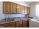 The laundry room features wood cabinets, marble counters, a stainless sink, and a washer at 1285 E Mcmurray Blvd, Casa Grande, AZ 85122