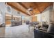 Spacious living room with a wood-beam ceiling, fireplace, and open-concept kitchen at 1285 E Mcmurray Blvd, Casa Grande, AZ 85122
