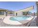 A beautiful backyard pool with lounge chairs and a large awning to provide shade on sunny days at 1285 E Mcmurray Blvd, Casa Grande, AZ 85122