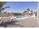 Beautiful outdoor pool with a rock surround, screened in lounge, and palm trees at 1285 E Mcmurray Blvd, Casa Grande, AZ 85122