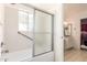 Bathroom with white cabinets, a tub, a shower, and a sliding glass door at 1309 E Meadow Ln, Phoenix, AZ 85022