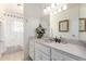 Bright bathroom featuring a white vanity with a neutral countertop and a shower/tub combo with curtain at 1309 E Meadow Ln, Phoenix, AZ 85022