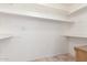 Walk-in closet featuring clean white walls and shelving at 1309 E Meadow Ln, Phoenix, AZ 85022