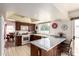 Traditional kitchen with wood cabinets, white appliances, and a marble breakfast bar overlooking the patio at 1309 E Meadow Ln, Phoenix, AZ 85022
