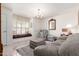 Bright living room featuring a cozy window seat, elegant chandelier, and comfortable seating at 1309 E Meadow Ln, Phoenix, AZ 85022