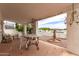 Covered patio with brick flooring, featuring outdoor seating, a statue, and stylish decor at 1309 E Meadow Ln, Phoenix, AZ 85022
