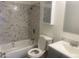 Updated bathroom with a modern vanity, and a shower featuring decorative marble-look tile at 1452 E Emerald Ave, Mesa, AZ 85204