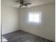 Cozy bedroom featuring gray vinyl flooring, and a ceiling fan at 1452 E Emerald Ave, Mesa, AZ 85204