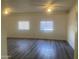Spacious bedroom with bright paint, gray vinyl flooring, ceiling fans, and natural light at 1452 E Emerald Ave, Mesa, AZ 85204