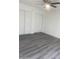 Spacious bedroom featuring new gray vinyl floors, closet and a ceiling fan at 1452 E Emerald Ave, Mesa, AZ 85204