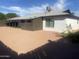Rear exterior of home with covered patio and gravel ground cover at 1452 E Emerald Ave, Mesa, AZ 85204