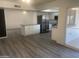 Bright, spacious kitchen with modern appliances, an island, and gray vinyl flooring at 1452 E Emerald Ave, Mesa, AZ 85204