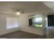 Bright and airy living room with a view of the modern kitchen, light paint and gray vinyl flooring at 1452 E Emerald Ave, Mesa, AZ 85204