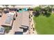 Aerial view of a home with solar panels, manicured lawn, and backyard pool at 15203 N 153Rd Dr, Surprise, AZ 85379