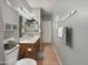 Updated bathroom with modern vanity, decorative mirror, and wood-look tile flooring at 15203 N 153Rd Dr, Surprise, AZ 85379