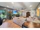 Open-concept living room featuring stylish decor, a large TV, and comfortable furnishings at 15203 N 153Rd Dr, Surprise, AZ 85379
