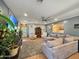 Spacious living room with comfortable seating, ceiling fan, and a view of the front yard at 15203 N 153Rd Dr, Surprise, AZ 85379